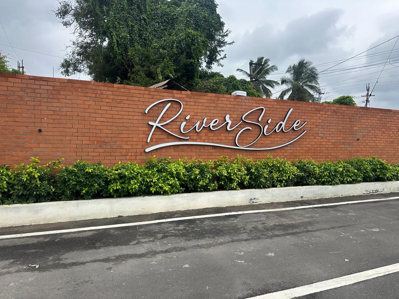 Riverside entrance signage on Thondamuthur Road